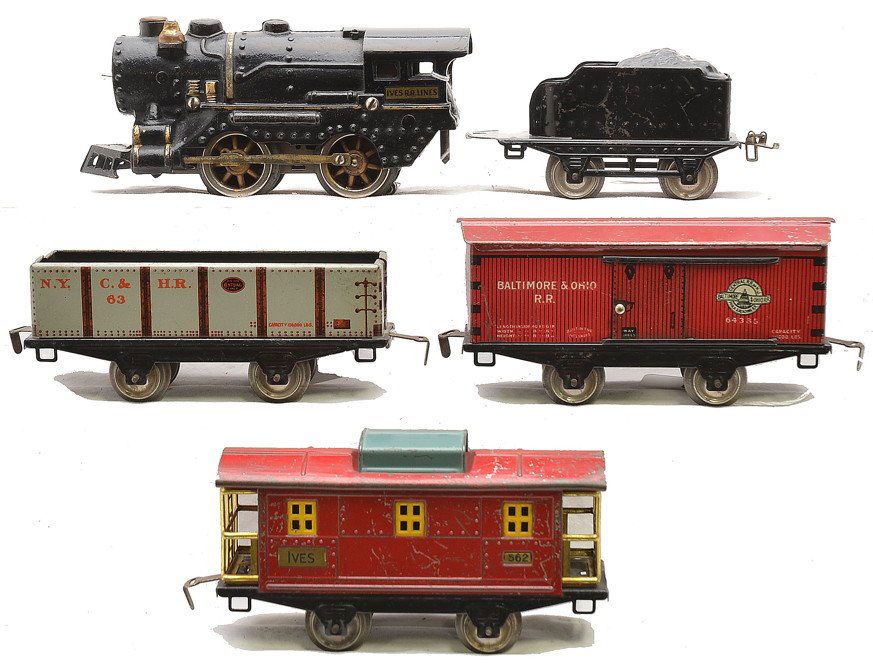 Ives Prewar Traders Fast Freight Set no. 570F: Ives prewar O gauge Traders Fast Freight set no. 570F, circa 1930 including; 1125 cast iron black steam loco, 17 tender, 563 gray lithographed N.Y.C. & H.R. gravel car, 564 red lithographed Baltimore