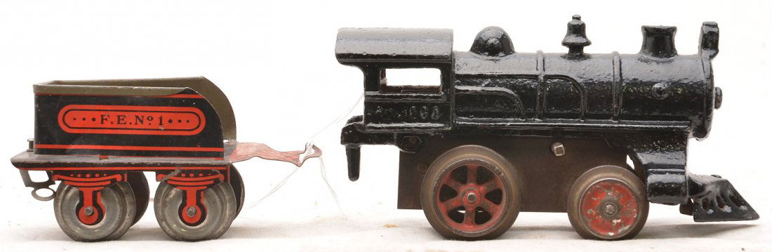 Ives Clockwork 1502 Black Loco FE No. 1 Tender: Ives prewar O gauge clockwork 1502 black cast iron steam loco with F.E. No. 1 lithographed four-wheel tender. The loco has No. 1502 embossed under the cab window on both sides. The loco has been repai