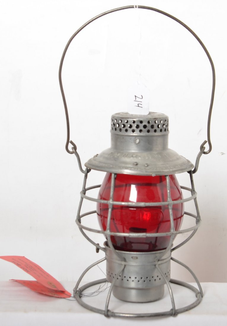 Adlake New Haven lantern with embossed red globe: Adlake New Haven lantern. Top is embossed with NYNH&HRR, and the red globe is embossed with the same lettering. Burner pot is included. Lantern has been cleaned. Also includes two Koolax hot box tags.