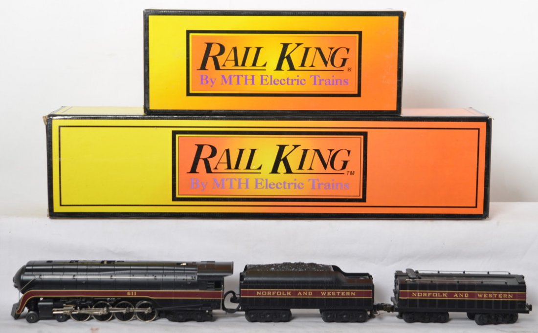 Railking N&W J class and auxiliary tender: MTH Railking modern O gauge MT-1105 Norfolk and Western J class steam locomotive in OB. Also included is 30-1117 auxiliary tender. Loco features smoke and whistle. Loco is C8 with run time. OBs have s