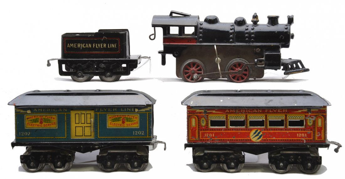 AF Lithographed Pass Set 15 120 1202 1201: American Flyer prewar O gauge lithographed passenger set including; 15 black cast iron clockwork steam loco with key, 120 tender, 1202 blue baggage and a 1201 red Pullman. The eight-wheel cars have bl