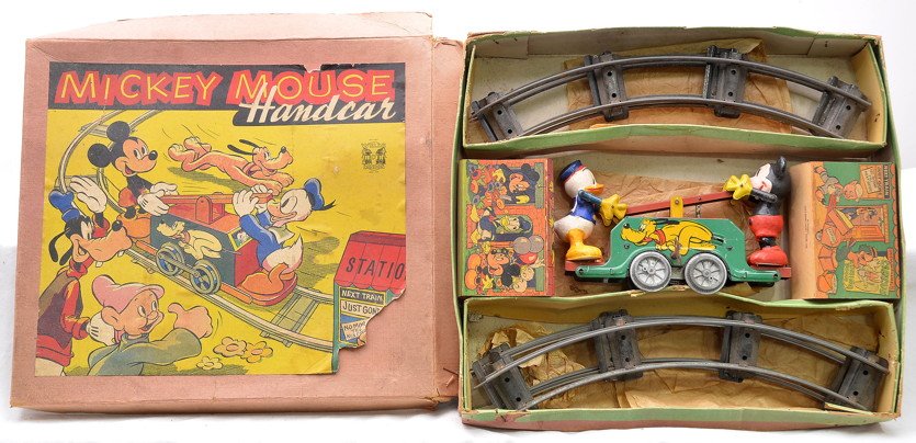 Wells of London M.Mouse D.Duck Hand Car Set: Wells of London Mickey Mouse and Donald Duck lithographed wind up hand car with cardboard stations, key and six pieces of curve track in OB that has original cardboard dividers. The on/off lever is br