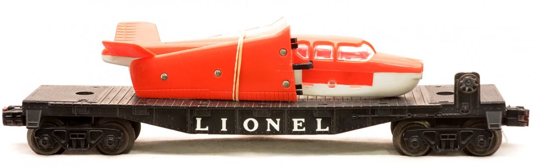 Lionel 6500 Flatcar w/Bonanza Plane Red/White: Lionel postwar 6500 black flatcar with a Bonanza airplane that has red top and wings. The propellor is missing from the airplane. One wing is missing a tab and is cracked. Airplane is C6. Flatcar is C