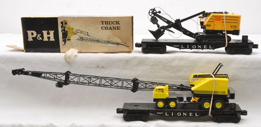 Lionel 6827 6828 Flatcars w/Harnischfeger: Lionel postwar 6827 flatcar with Harnischfeger power shovel and 6828 flatcar with Harnischfeger crane, C6. Some of the pieces are broken on the loads. There is a box for the 6828-100 Harnischfeger tru