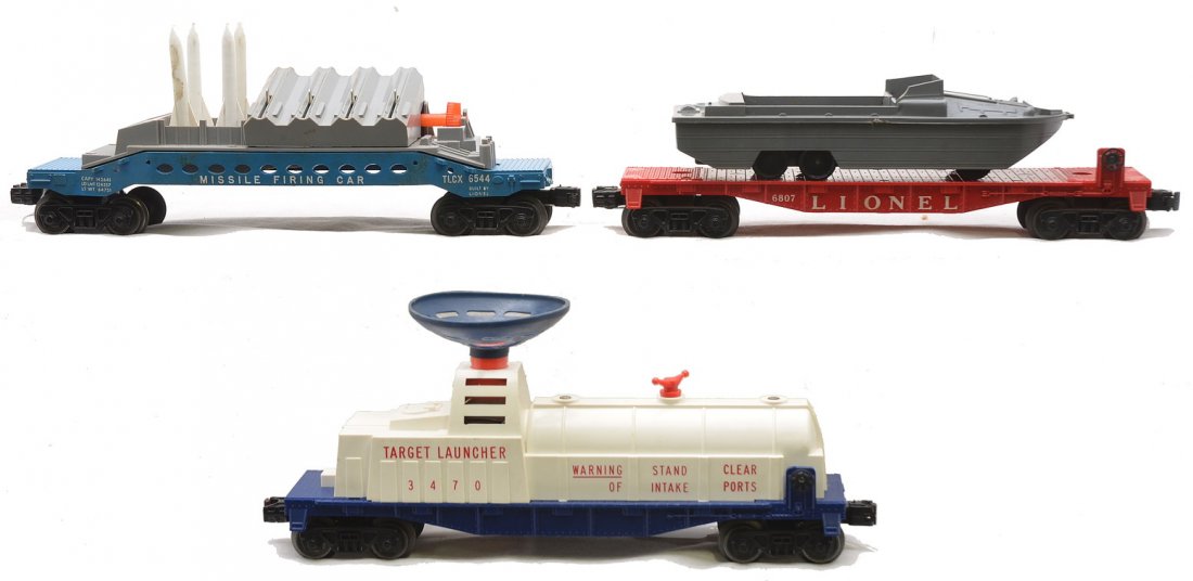 Lionel Postwar Freight Cars 6544 3470 6807: Lionel postwar freight cars including; 6544 missile firing car with white console and two broken brake wheels, 3470 target launcher and a 6807 flatcar with a U.S.M.C. boat. The 6544 is C6. The other t