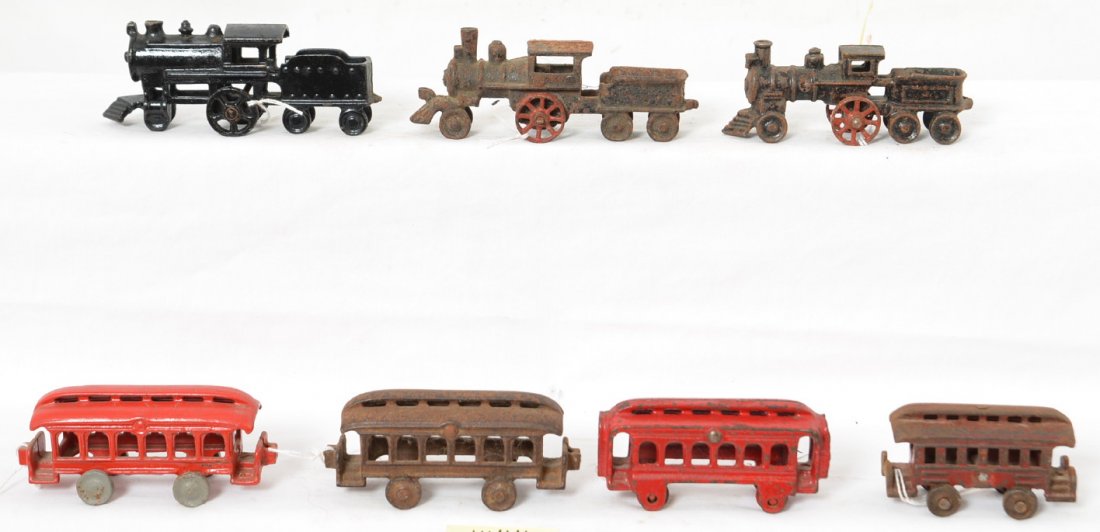 Cast Iron steam locos with tenders and passenger cars: Early cast iron pull floor toys, three locos with attached tenders, and four passenger cars. Trains are sold as they are shown in our photos with NO returns. Loco and tenders measure approximately 5 i