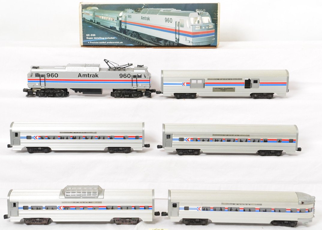 Williams Amtrak E-60 and aluminum passenger cars: Williams modern O gauge Amtrak E-60 and passenger cars. E60 loco is C6-7 with a broken pickup roller, light spot of frame rust, and mildew on the roof. Five aluminum bodied passenger cars are