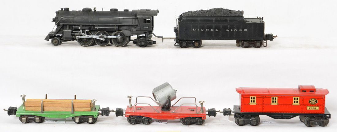 Lionel 224E/2224W, 2651, 2620, 2682 steam freight: Prewar Lionel O gauge 224E steam locomotive with 2224W whistle tender, 2651 flatcar w/lumber, 2620 operating searchlight car, and 2682 caboose, trains look very nice C6 area.