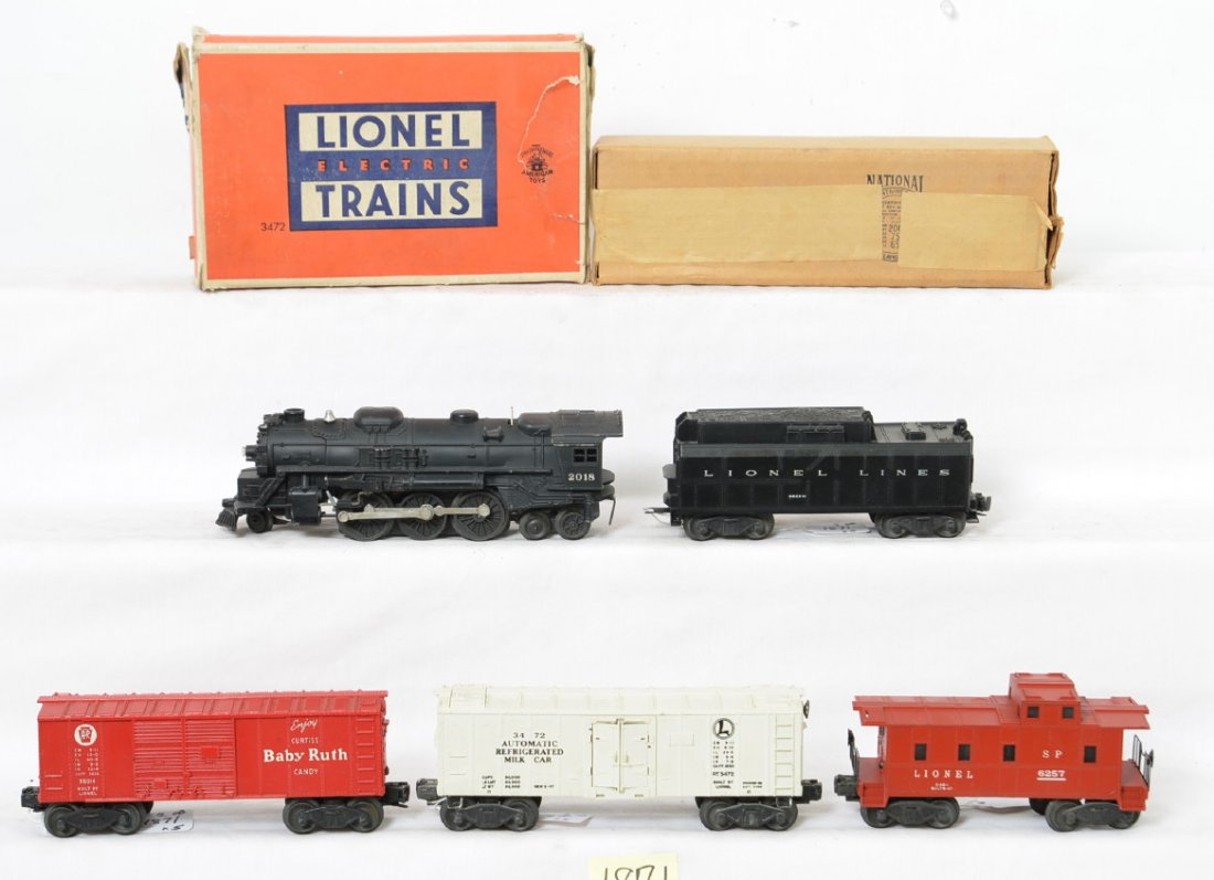 Lionel 2018 in OB/6026W, 3472 in OB, 6014, 6257: Postwar Lionel O gauge 2018 steam locomotive and 6026W whistle tender with 3472 milk car, X6014 Pennsylvania Baby Ruth boxcar, and 6257 SP type caboose. Trains look nice C6. 3472 box has torn and miss