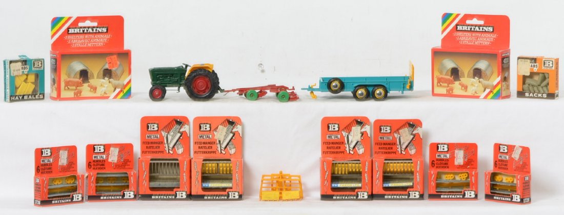 Large grouping of Britains: tractor, gang mower, hay: Large grouping of Britains diecast farm toys and accessories, many in original boxes. Tractor, gang reel mower, three point hitch hay forks, trailer, C6-7. Four 1715 metal feed manger, two 4703 2 shel
