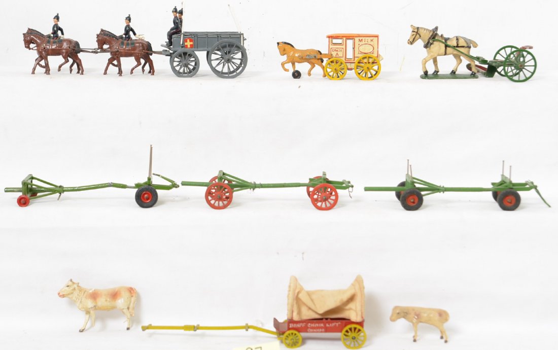 Britains horse drawn wagon, Manoil Milk wagon, more: Group of horse drawn items, Britains wagon with Swiss herald, drivers and coachmen. Three Britains adjustable length trailers. Made in England covered wagon. Manoil/Barclay? Grade A Milk wagon. Wend-A