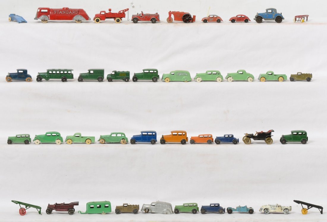 Thirty-nine Tootsietoy diecast toy vehicles: Group of Tootsietoy diecast lead toy cars, trucks, race cars, fire trucks, tow truck, steam roller, travel trailer, and other vehicles. Some are repainted, but few. Group overall looks C6-7 area. Sold