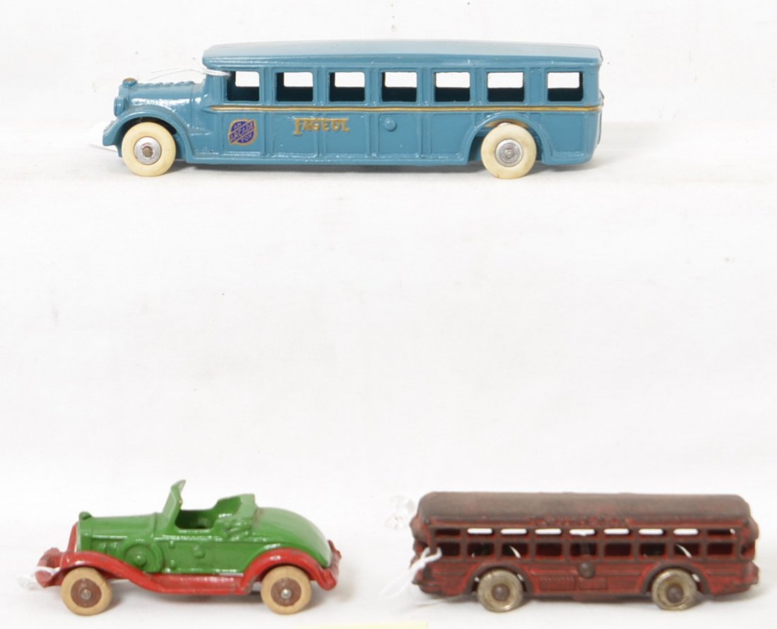 Three cast iron vehicles, Fageol, take-apart, Twin: Three cast iron vehicles; Arcade cast iron No. 3 Fageol passenger/touring bus, approximately 8 inches long, nicely restored. Cast iron Twin Coach city/passenger bus 5 inches long with steel wheels. Ap