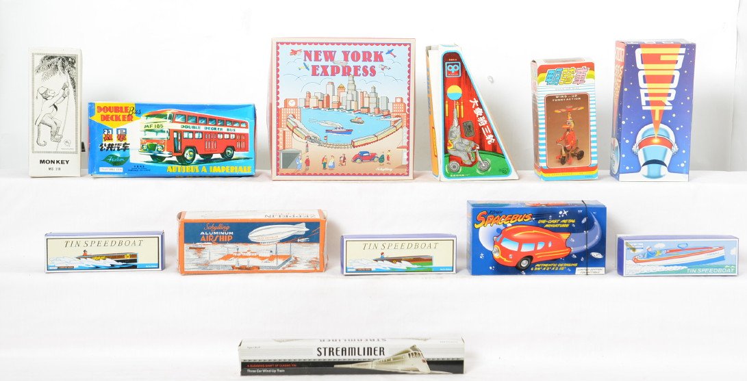 12 Schylling & Others Reproduction Tin Toys in OB: Lot includes Schylling Tin Speedboat x 3, New York Express, chrome plated Streamliner three-car train, and Aluminum Airship. Also includes Chinese made Duck on Bike, Double Decker Bus, Elephant on Bik