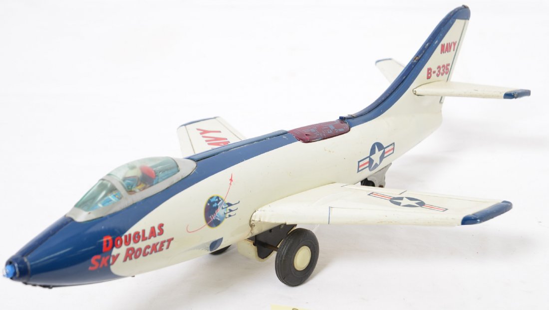 Linemar Tin Friction Douglas Sky Rocket: Very nice shape with minor play wear and rubs and a small paint touch up on belly but the nose is missing. The clear red cover to the Ã’spark chamberÃ“ has a small crack. Friction mechanism work