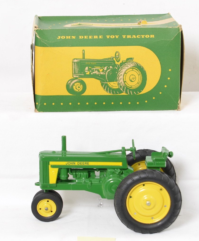NOS Eska John Deere Model 60 in Box: Stunning new old stock example with no play wear. This version has long yellow decals along the side with John Deere in green. There are two tiny paint rubs, one on each rear wheel but otherwise perfe