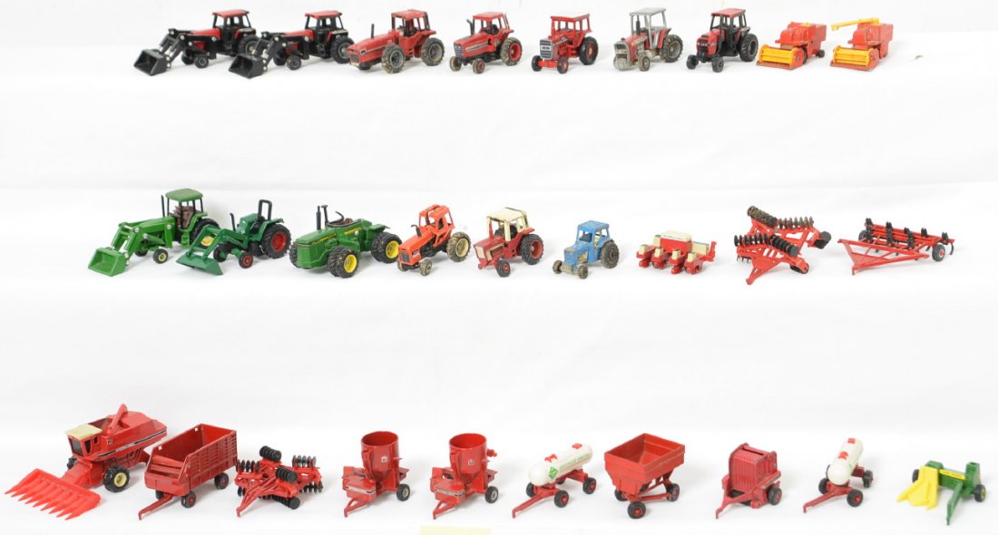 Large Group of 1/64 Toy Tractors & Parts: Group of mostly modern Ertl and Matchbox die cast toy tractors and implements in played with condition, some even have dirt on their wheels.