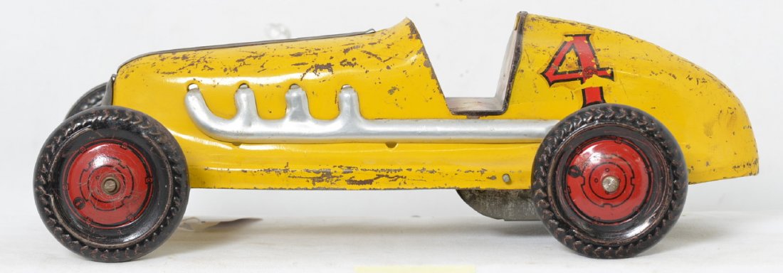 Marx Wind Up Indy Midget Racer: This car is all original and missing some paint due to scratches and play wear. The driver is also missing as well as the steering wheel. It is made of pressed steel with tin wheels and a very solid t