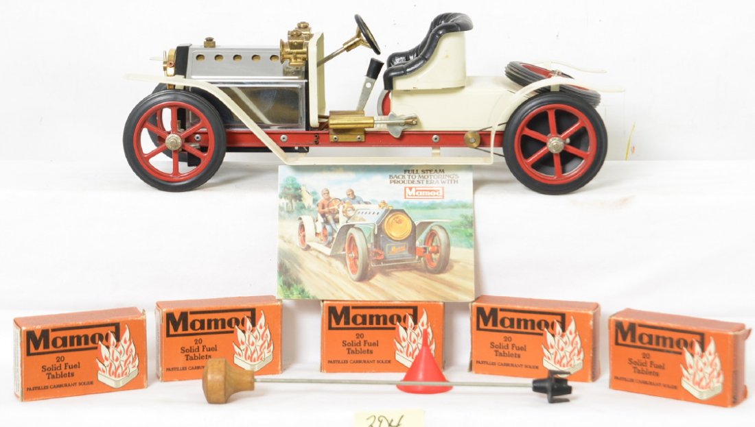 Mamod Steam Roadster & Fuel Tablets: The roadster is in great shape with some small paint chips and dust from age. It does not appear to have even been used. The lot includes five boxes of 20 solid fuel tablets, a small funnel and steeri
