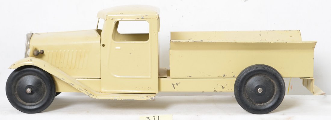 Unmarked Pressed Steel Tow Truck: This truck is in nice shape and appears to be all original but is missing the tow boom. It is equipped with lights and they still work with a D battery. The paint looks really nice on this old fella w