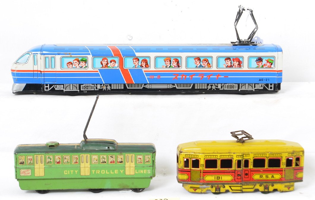 Group of Tin Litho Trolleys: Group includes an Ichiko passenger train with a damaged pantograph and a few dents underneath, Cragstan City Trolley lines friction toy with a lever action friction drive in nice shape but has dents o