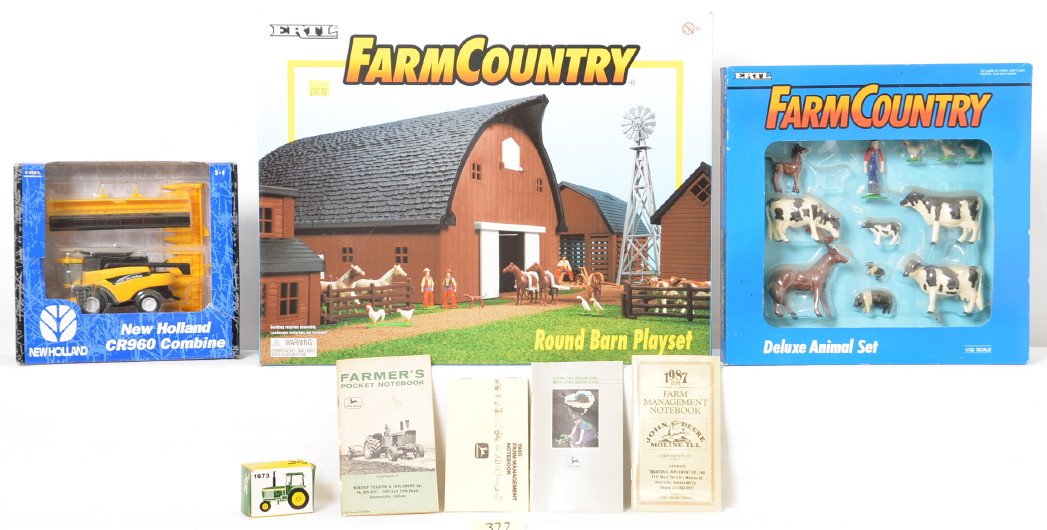 2 large flats of Ertl and Norscot John Deere and CAT: Two 13 x 26 flats filled with Ertl, Norscot, and Tonka farm toys. Most are John Deere or Caterpillar. Many are new C10 in their packages. See photos for best description.