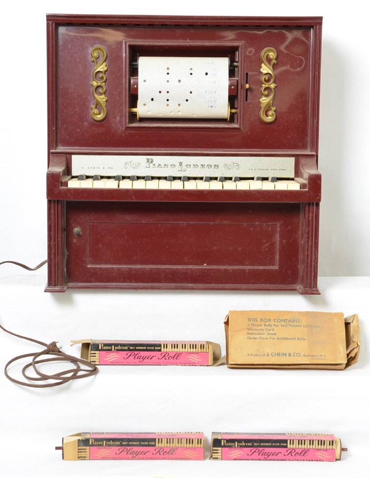 Chein Lodeon Player Piano & Rolls: Piano works and is in nice shape. Includes six rolls and four boxes. Piano measures 20 1/2Ã“ x 9 1/4Ã“ x 20 1/8Ã“.