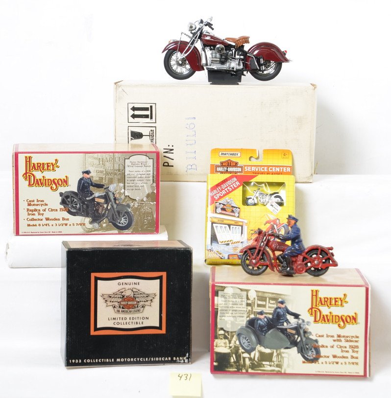 Group of Harley Davidson Collectibles: Lot includes two MIB cast iron motorcycles, a Franklin Mint Indian motorcycle that was opened but doesnÃ•t appear to have been removed from the Styrofoam, a bank, a Matchbox Service center Playset 
