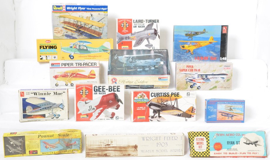 Group of Civlian Airplane Model Kits: Lot includes 14 kits, seven sealed and seven with shrink wrap removed. There are three balsa kits and the rest are plastic. Manufacturers include Lindberg, Monogram, Revell, Sterling Guillows, Minicra