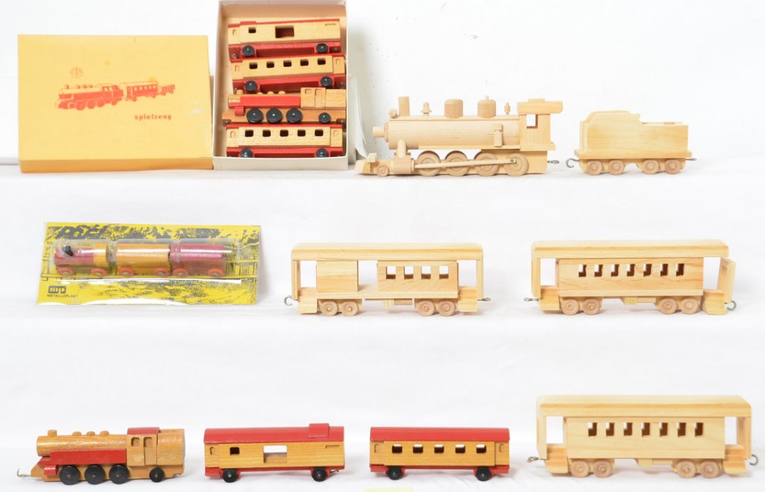 Group of Wooden Toy Trains: This lot includes toy trains from East Germany and possibly the USA. The large undecorated set is hand made but has no markings. The end has fallen off of one of the passenger cars but could easily be