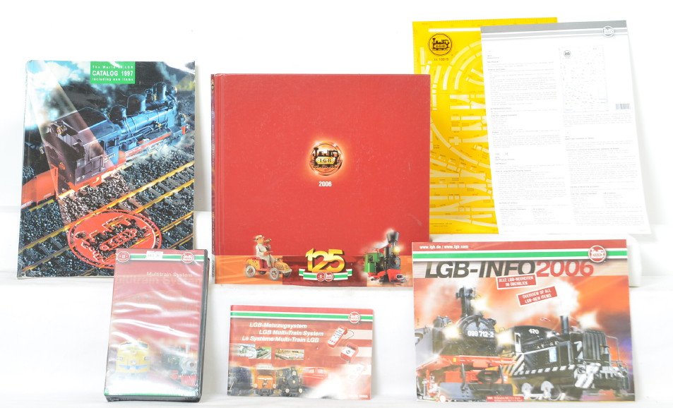LGB 125 years book, 1997 catalog, layout planning kit,: Modern era LGB G scale 125 years of The World of LGB 2006 hard bound book, 1997 catalog, 10015 track planning kit, Multitrain System VHS tape and mini-catalog, C7-10.