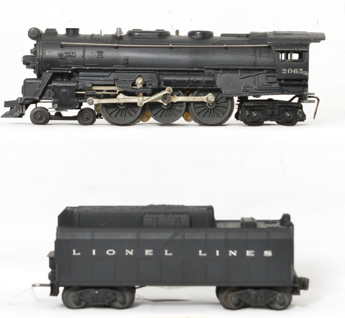 Lionel 2065 steam loco w/whistle tender: Postwar Lionel O gauge 2065 steam loco with unnumbered whistle tender. Loco has dinged cab roof, missing and bent pilot steps, etc. Tender looks sharp but has slightly cracked front step. Trains are s