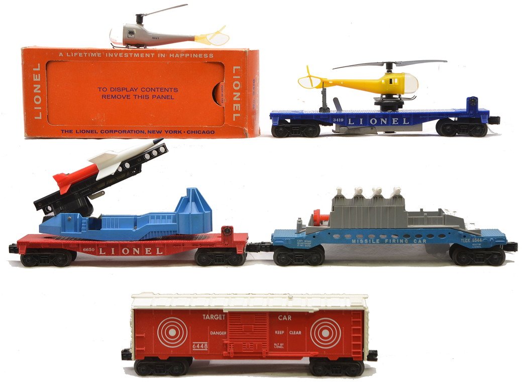 Lionel Freight Cars 6544 3419 OB 6650 6448: Lionel postwar freight cars including; 6544 missile firing car with white console, 3419 operating helicopter car with yellow helicopter in OB that has most flaps attached, 6650 IRBM rocket launcher wi