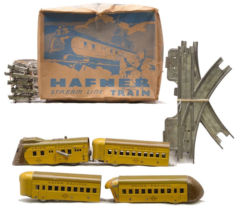 Hafner Litho Yellow/Brown UP Pass Set OB: Hafner lithographed yellow and brown Union Pacific streamlined passenger set in OB including; M-10000 clockwork steam loco, two coaches, observation car, pair of switches and ten curve track sections.