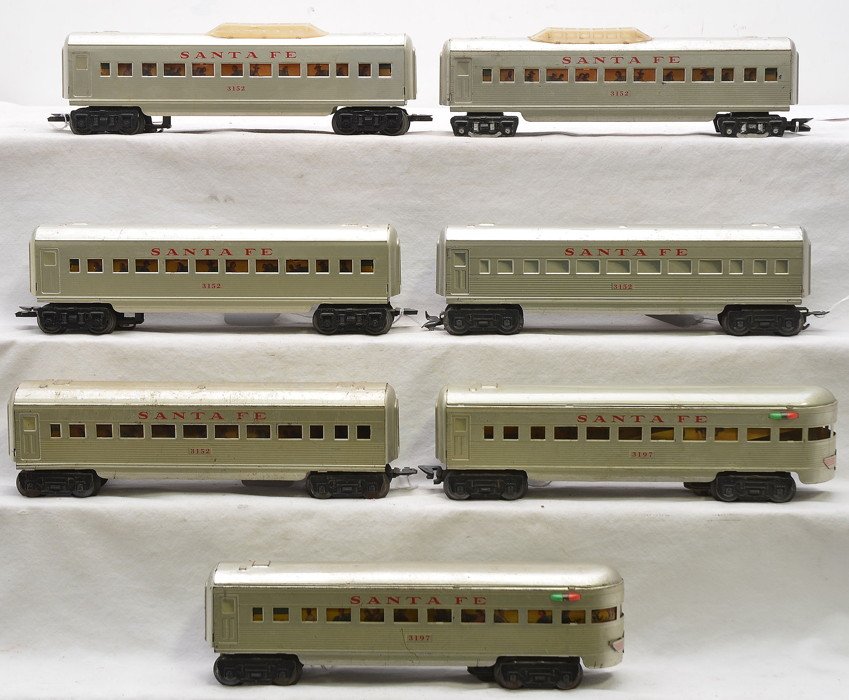 Marx Silver SF Pass Cars 2-3152 3-3152 2-3197: Marx silver Santa Fe passenger cars including; two 3152 vista domes, three 3152 Pullmans and two 3197 observation. One of the vista domes is missing the wheels. Cars are C5
