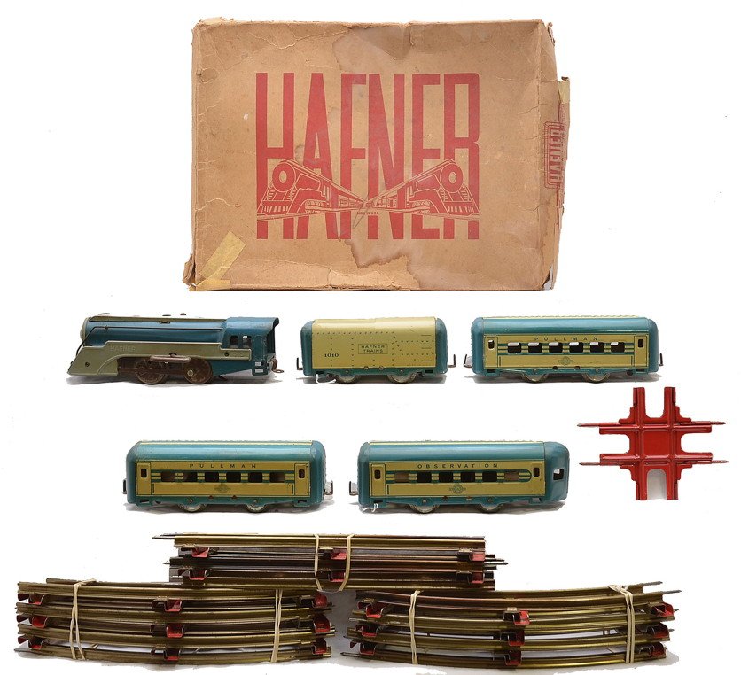 Hafner Litho Blue/Cream Pass Set Boxed: Hafner prewar O gauge lithographed passenger set in worn OB containing; 1010 steam clockwork outline blue boiler with gray side boards and boiler front, tender, two Pullmans, observation car, twelve c