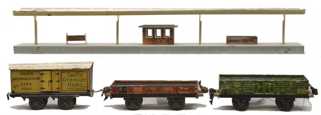 Marklin Station 17610 17720 Bing Swift Reefer: Marklin station, green 17610 wagon and a 17720 brown stake car. Also included is a Bing lithographed Swifts Premium Ham refrigerator car. All items are C5.