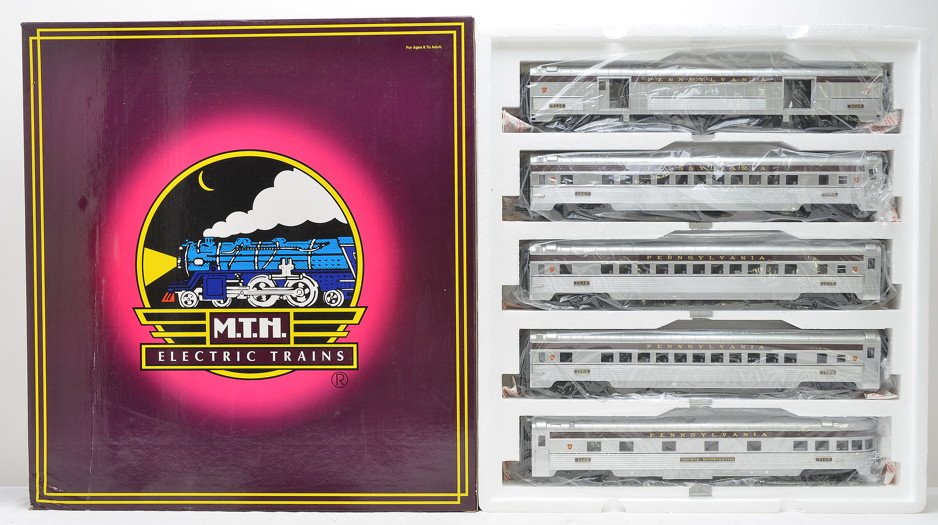 MTH 20-6530 PRR Streamlined Pass Car Set MIB: MTH 20-6530 70 foot scale Pennsylvania streamlined passenger car set including a baggage, three coaches and an observation car in OB. Cars have never been run, C10.