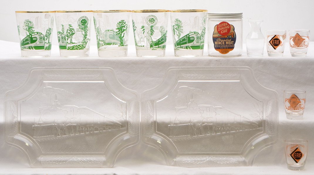 Selection of RR Southern Glasses Erie Shot Glasses: Selection of railroad glassware; Five Southern Railroad glasses, four Erie shot glasses, miniature carafe and two clear glass serving trays. Also included is a Extra Dining Car brandied Mince Meat jar