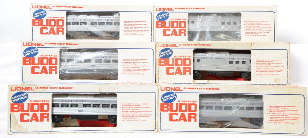6 Lionel Baltimore and Ohio Budd cars 8764 8765 8767: Lionel modern O gauge Baltimore and Ohio Budd cars in OBs. Includes two of each of the following 8764 powered car, 8765 dummy baggage, and 8767 coach. Cars are generally C7 condition. OBs have mild to