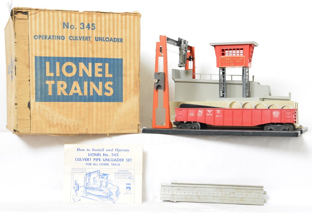 Lionel 345 operating culvert unloader in OB: Original unloader that has been played with and has dust and dirt on it as well as having a broken hand rail. There are scratches paint wear and minor rust on the base and other metal parts. there are