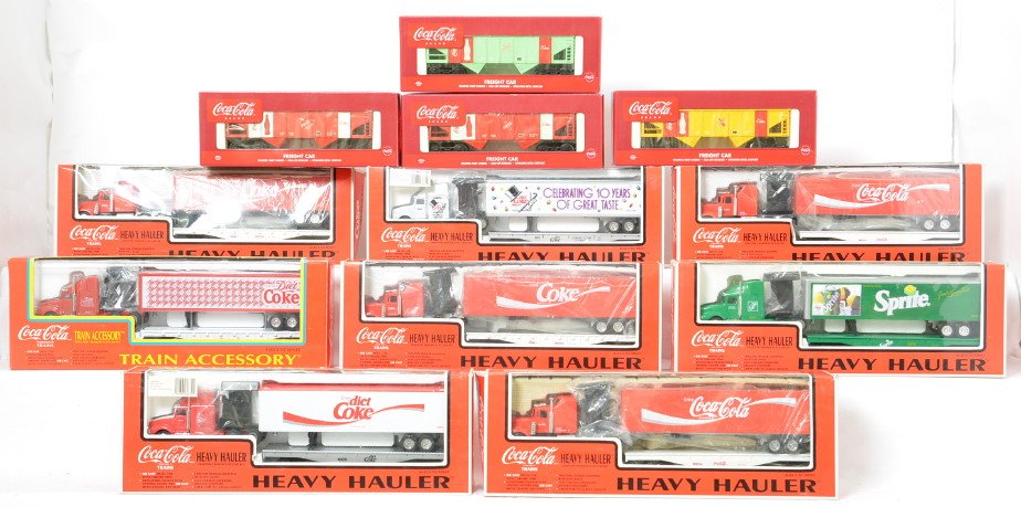 12 K Line Coca Cola hoppers and flats with trailers: K Line modern O gauge Coca Cola freight cars in OBs. Includes K-53272A hopper four pack, 666703TT Diet Coke flat with trailer, 6667TT Diet Coke flat with trailer, 6670TT Sprite flat with trailer, 6634