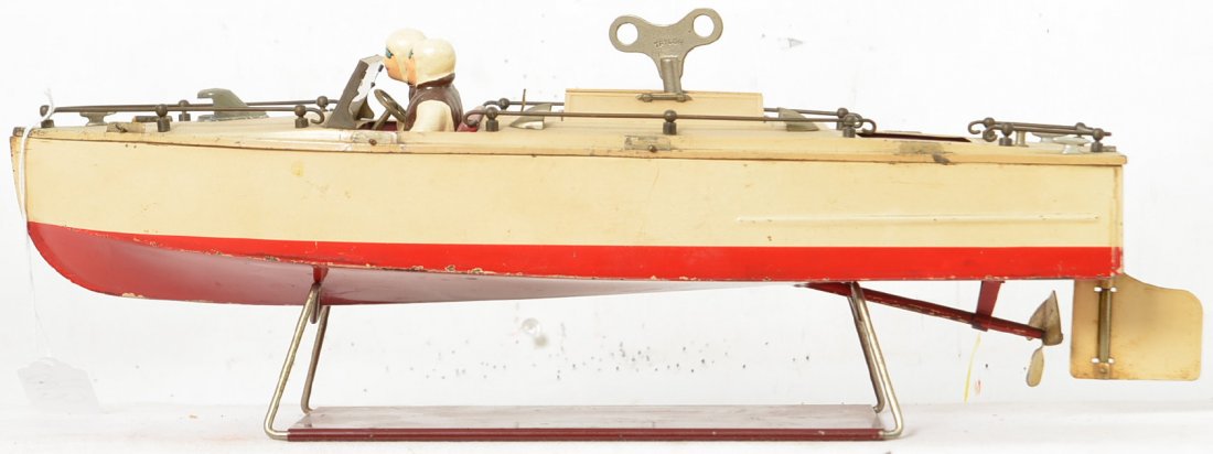 Lionel Craft 43 prewar boat with stand: Boat is not all original as evidenced by the railings around the boat and the turned up metal tabs with cotter pins in them to hold the top in place. The figures look nice and have a lot of paint rema