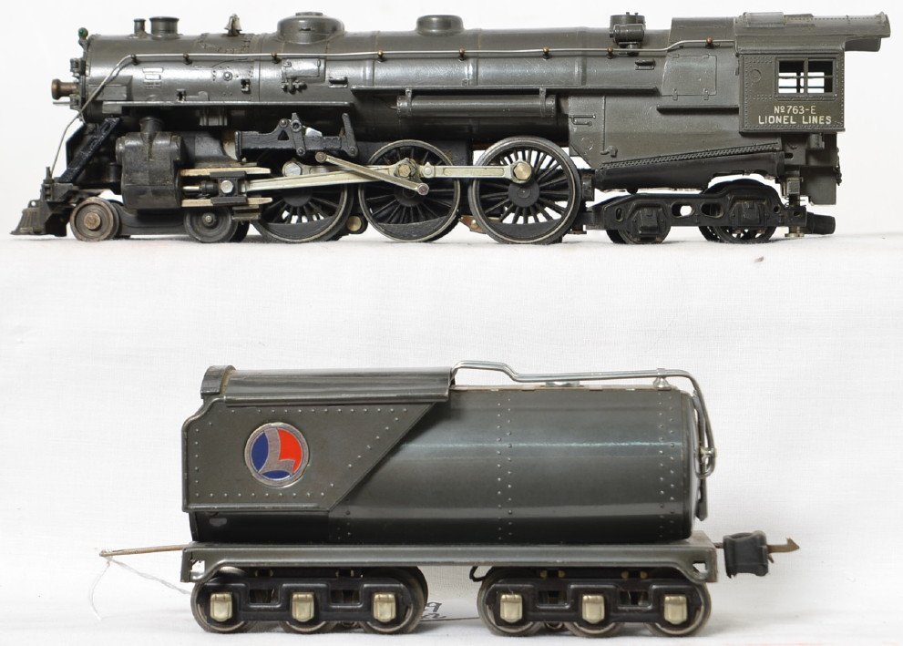 Lionel 763-E Hudson & 263 W tender gunmetal: Locomotive is nice looking but has a very minor ding on one side of the cab roof and is missing the whistle. Tender is in nice shape with scratches here and there but not too much, C6 to C6 plus.