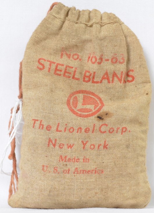 Lionel 165-83 steel blanks: Nice original 165-83 bag of steel blanks. The tops of the numbers are a bit faded but still discernible. Bag is browned and does have a small stain on the front and is over half full of original metal