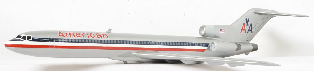 American Airlines Boeing 727 Desk Display jet: Vintage desk display jet with fantastic graphics but there is a small broken piece off of the back edge of the left wing and a small ding on the top of the wing as well. The small piece is here and co