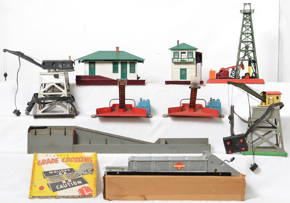 Lionel Postwar O gauge accessories 165 182 455 397 397: Lionel Postwar O gauge accessories including 165 and 182 gantry cranes, two 397 coal loaders, 455 oil derrick, 132 illuminated station, 445 operating switch tower and 264 lumber loader. Also included