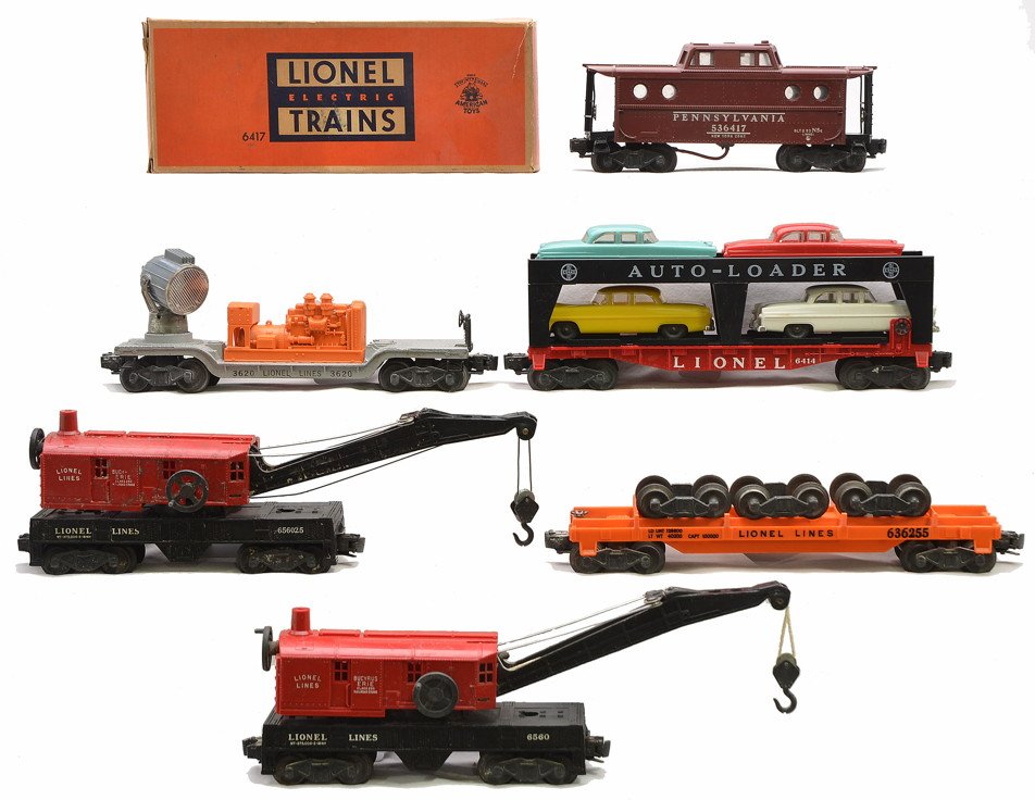 Lionel 3620 6414 6560 6560-25 6362-55 6417: Lionel postwar freight cars including; 3620 searchlight car with orange generator, 6414 Evans auto loader with four cars, 6560 and 6560-25 Bucyrus Erie cranes, 6362-55 truck car with three sets of tru