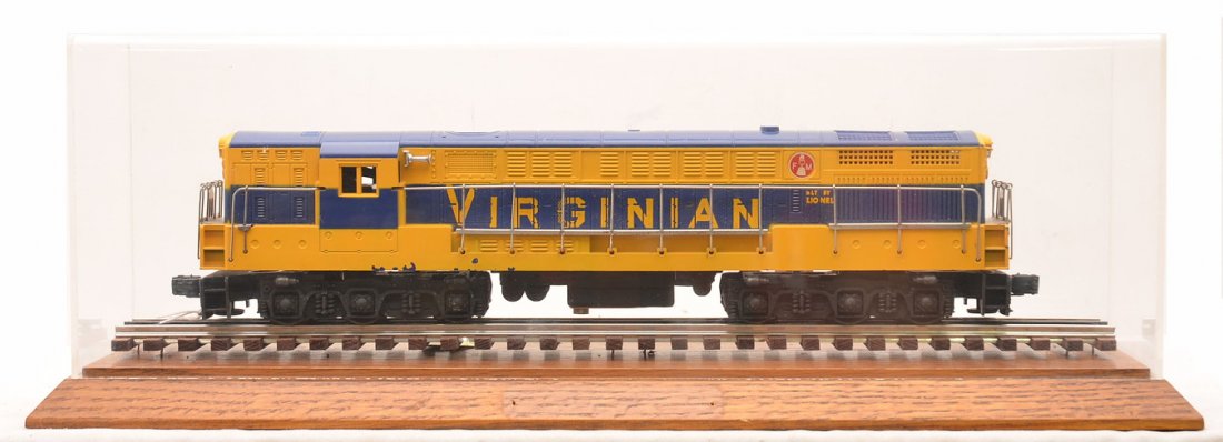 Lionel 2331 Virginian FM Diesel w/ Display Case: Lionel postwar 2331 Virginian FM Train Master electric diesel. The chassis has been repainted. The shell is original and has screw hole cracks. Shell is C7. Also included is an oak wooden display boar