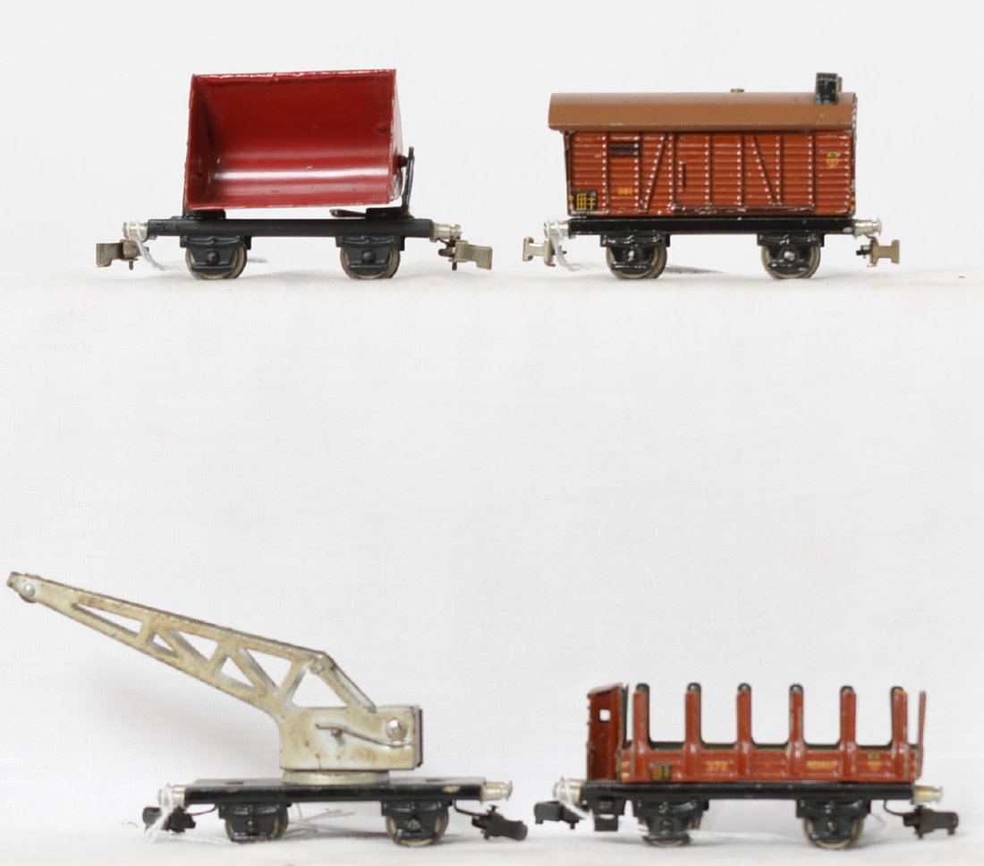 4 Marklin prewar four wheel cars 10T crane, 372, 381,: Marklin prewar four wheel freight cars. Includes 10T crane with black base, 362 side dump wagon with repainted gondola and one detached section of the A frame, 372 stake car, and 381 boxcar. Trains ar